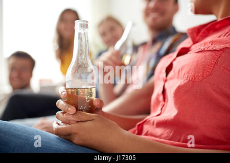 Close up di donna con bottiglia di birra e gli amici Foto Stock