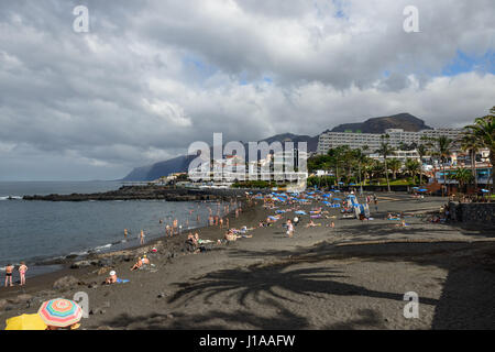Arena Beach con le ombre degli alberi di palma nel giorno nuvoloso in Puerto de Santiago, Tenerife, Isole Canarie, Spagna. Foto Stock