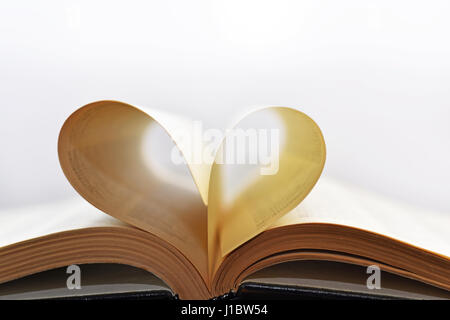 Libro aperto con cuore formare fogli. Foto Stock