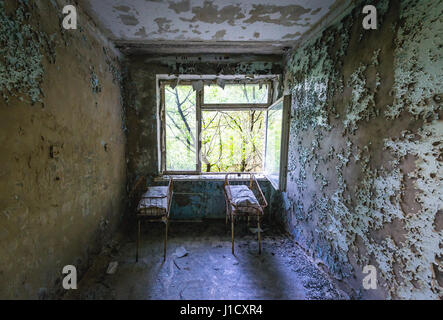 Culle per neonati in ospedale n. 126 di pripjat città fantasma, la centrale nucleare di Cernobyl la zona di alienazione intorno al reattore nucleare disastro, Ucraina Foto Stock