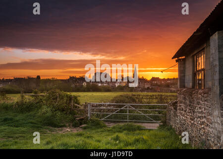 Regno Unito - Previsioni del tempo - Dopo una notte fredda in aprile, un bel mattino cielo si illumina di rosso al di sopra del Wiltshire città mercato di Malmesbury. Foto Stock