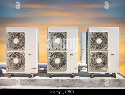 Compressore aria parte macchina del sistema di aria condizionata sul tetto piatto con lo sfondo del cielo. Foto Stock