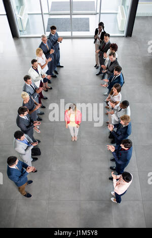 Sorridente business partner plaudendo alla felice fiducioso leader Foto Stock