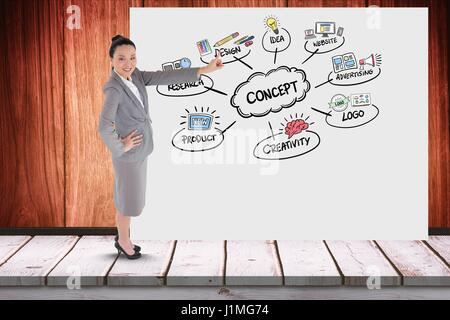 Digital composito di imprenditrice gesti sul tabellone con varie icone mentre in piedi in ufficio Foto Stock