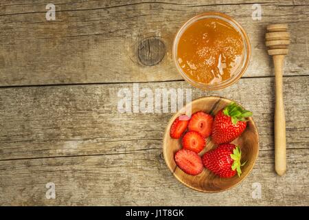 Ape Miele e fragole fresche. Sweet Food. Vendita di miele Foto Stock