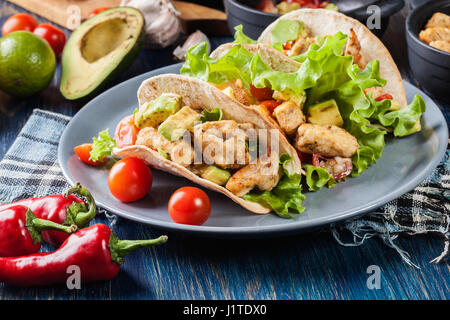 Autentica tacos messicano con pollo e salsa con avocado, pomodori e peperoncino. Cucina messicana. Foto Stock
