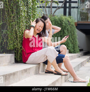 Donna Gramacing fissare i capelli aggrovigliati Foto Stock