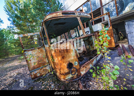 Rusty bus davanti di abbandono di Giove in fabbrica pripjat città fantasma della centrale nucleare di Cernobyl la zona di alienazione in Ucraina Foto Stock