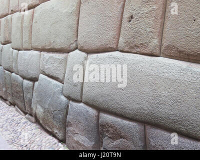 Parete Inca in materiali naturali pietre vulcaniche, perfettamente sagomati, patrimonio di storia e architettura in Cusco, Perù. Foto Stock