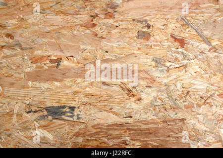 Irregolari sullo sfondo di legno di flakeboard. Ruvida miscela di forme in legno foglio materiale di legname. Foto Stock