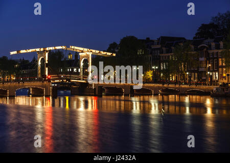 Magere Brug (ponte Magere) e il fiume Amstel al crepuscolo, Amsterdam, Paesi Bassi Foto Stock