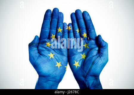 Primo piano delle palme di un uomo messo insieme modellato con la bandiera della Comunità europea su un fondo bianco, con una piccola aggiunta di vignette Foto Stock