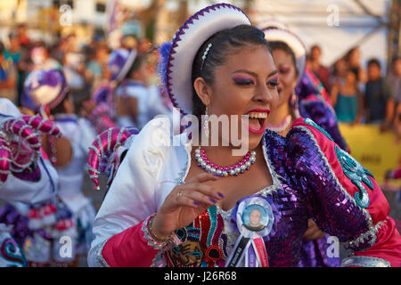 Elementi femmina di un Caporales il gruppo di musica da ballo in costumi ornati di eseguire l'annuale Carnaval Andino con la Fuerza del Sol a Arica, Cile. Foto Stock