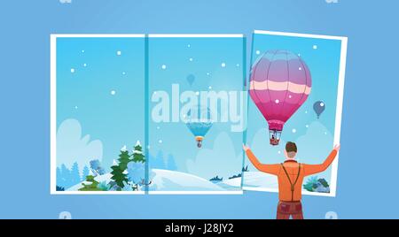 Uomo che guarda in finestra in aria colorate mongolfiere volare nel cielo invernale Illustrazione Vettoriale