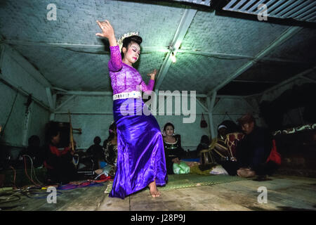 Una giovane donna che esegue il jaipong, una tradizionale danza Sundanese, sul palco durante il festival annuale del ringraziamento del raccolto a Giava Occidentale, Indonesia. Foto Stock