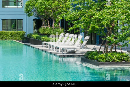 Piscina con sedie a sdraio Foto Stock
