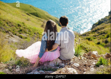 Vacanza giovane camminando sulla spiaggia insieme all amore azienda intorno all'altro. Felice interracial coppia giovane, donna asiatica e uomo caucasico. Foto Stock