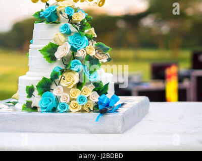 Bella torta di nozze con blu e giallo rose Foto Stock