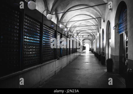 In bianco e nero di arcade colore selettivo luce blu negozi chiusi padova veneto italia Foto Stock