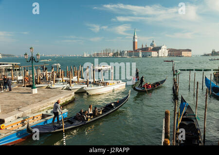 Gondole sul bacino di San Marco a Venezia. Chiesa di San Giorgio Maggiore all'orizzonte. Foto Stock