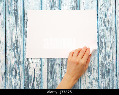 Donna di mano girando sul foglio di carta Foto Stock