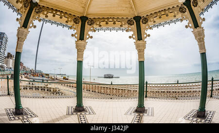 Vista di fish eye tra il Victorian bandstand e i resti del distrutto Molo Ovest di Brighton e Hove (UK) Foto Stock