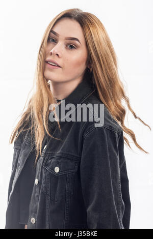 Un grazioso 15 anno vecchia ragazza in studio contro uno sfondo bianco nel Regno Unito Foto Stock