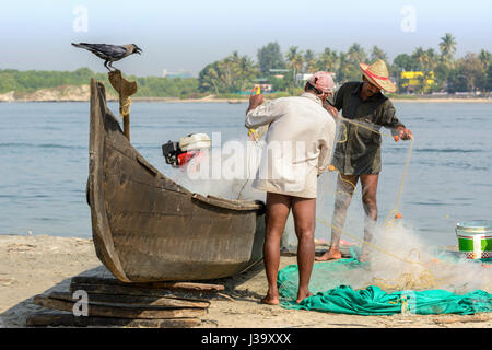 I pescatori del Kerala di controllare le loro reti sulla sponda a Kochi (Cochin), Kerala, India del Sud, Sud Asia Foto Stock