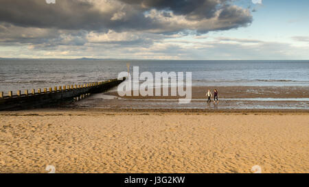 Un paio di camminare sulla spiaggia di Portobello sul Firth of Forth costa a Edimburgo, Scozia. Foto Stock