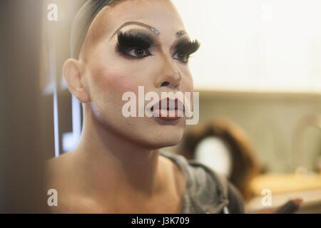 Giovane uomo applicazione trascina il trucco Foto Stock