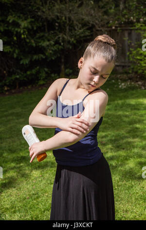 Di undici anni ragazza l'applicazione di crema solare in Issaquah, Washington, Stati Uniti d'America Foto Stock