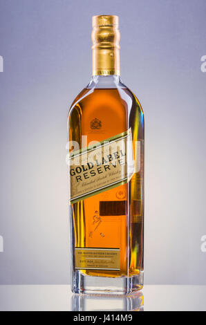 Johnnie Walker etichetta oro whisky mescolato sul gradiente dello sfondo. Foto Stock