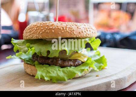 Freschi e deliziosi hamburger cheeseburger con grigliate di carni bovine burger, formaggio su un tavolo in un ristorante Foto Stock