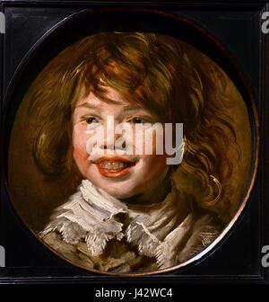 Il dipinto 'Lachende jongen' (ragazzo che ride) di Frans Hals è un'opera d'arte notevole del XVII secolo, ospitata nelle Mauritshuis a l'Aia, Paesi Bassi. Il ritratto cattura l'espressione vivace e il carattere del suo soggetto. Foto Stock