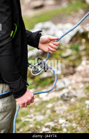 Belayer arrampicata corda tiene nelle sue mani. Foto Stock