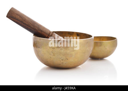 Il Tibetano handcrafted SINGING BOWLS con bastoni isolati su sfondo bianco Foto Stock