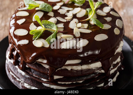 Crepes di cioccolato la torta con panna montata e mandorle macro sul tavolo orizzontale. Foto Stock