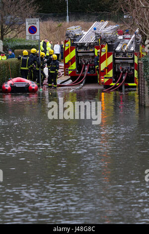 Purley, Londra, Regno Unito. I vigili del fuoco lavorare alla pompa inondazione lontano dalla strada residenziale. Foto Stock