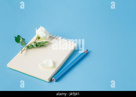 White rose fiori sono sul notebook Foto Stock
