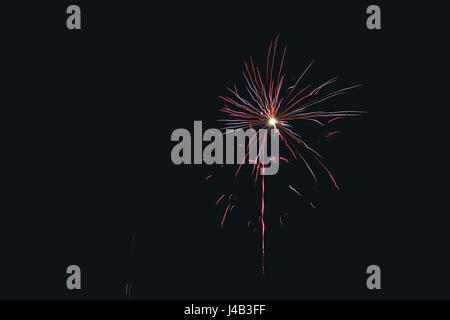 Fuochi d'artificio che esplodono nel cielo notturno in variopinti colori alla vigilia di capodanno Foto Stock