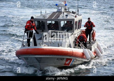 Una stazione della Guardia Costiera Port Angeles equipaggio a bordo di un 45-piede Risposta unità Boat-Medium accanto il coltello pesce spada, un 87-piede Protector-Class Marine imbarcazione di pattuglia, in Port Angeles, nello Stato di Washington, 6 febbraio 2017. Il Port Angeles piccola barca equipaggio assistito il pesce spada equipaggio dopo una fuoriuscita di petrolio si è verificato nella 87-piede della nave camera del motore. Stati Uniti Coast Guard foto di Sottufficiali di seconda classe Flockerzi Ali. Foto Stock