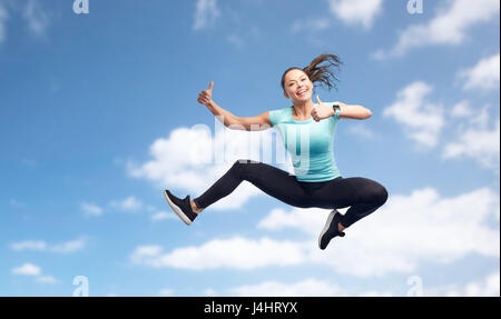 Happy sport giovane donna che si tuffa nel blu del cielo Foto Stock