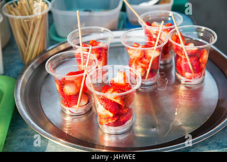 Fragola in bicchieri di plastica al mercato di strada Foto Stock