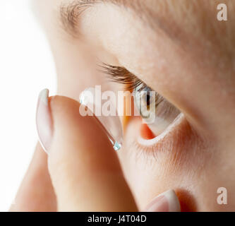 Donna inserti di lenti a contatto. La messa a fuoco sugli occhi Foto Stock