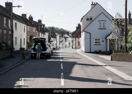 Una giornata di sole in Barrow Street a Much Wenlock, Shropshire, Regno Unito. Una pigra domenica pomeriggio e una pittoresca strada Britannica.. Foto Stock