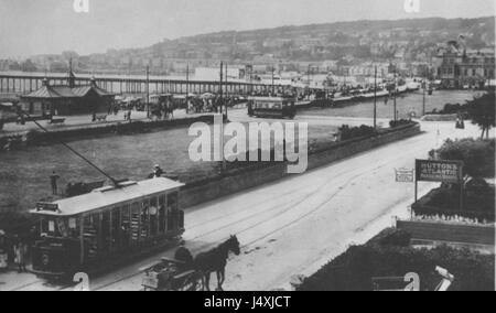 Questa immagine cattura l'iconica spiaggia Weston-super-Mare in Inghilterra, con i prati della spiaggia e i tram storici. La foto riflette la popolarità della spiaggia tra la fine del XIX e l'inizio del XX secolo. Foto Stock
