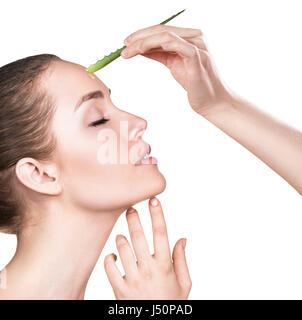 Giovane donna utilizza aloe vera olio per la pelle isolati su sfondo bianco Foto Stock