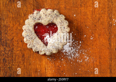 Biscotti frollini con marmellata il deposito su sfondo di legno Foto Stock