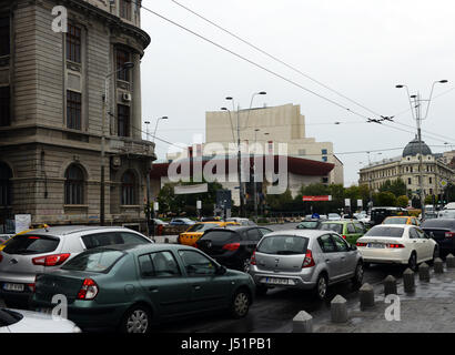 Il traffico su Nicolae Bălcescu avenue vicino al teatro nazionale e universitate cerchio in Bucharest city center. Foto Stock