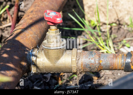 Il vecchio rubinetto di acqua su un tubo arrugginito Foto Stock